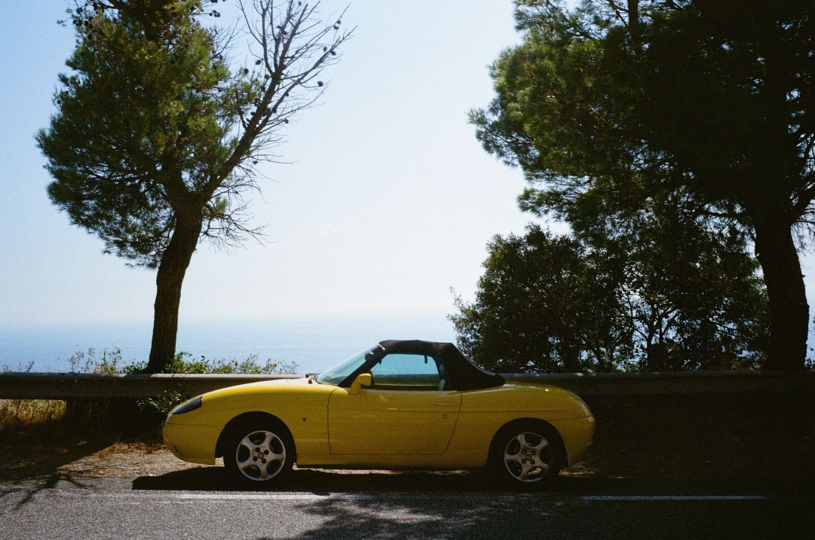 Rental car on a scenic coastal road in the Riviera Maya